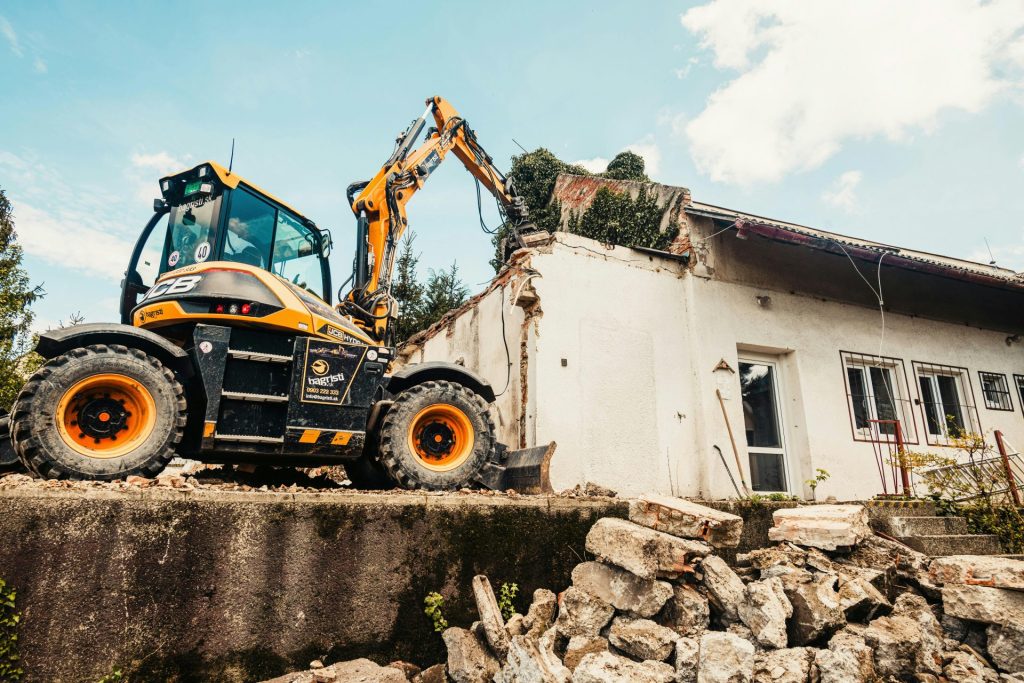 A construction vehicle is parked in front of a house